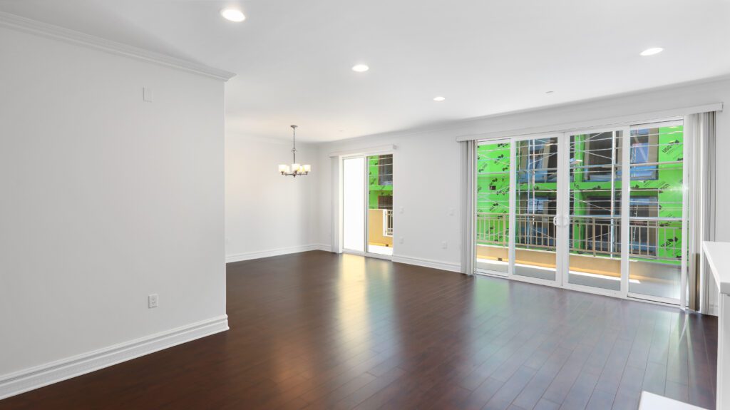 Spacious, empty living room area leading to a large terrace